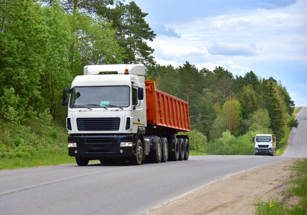 Truck With Tipper Semi Trailer Transported Sand From the Quarry on Driving Along Highway — Container, Machinery & General Freight Transport in Mount Isa, QLD