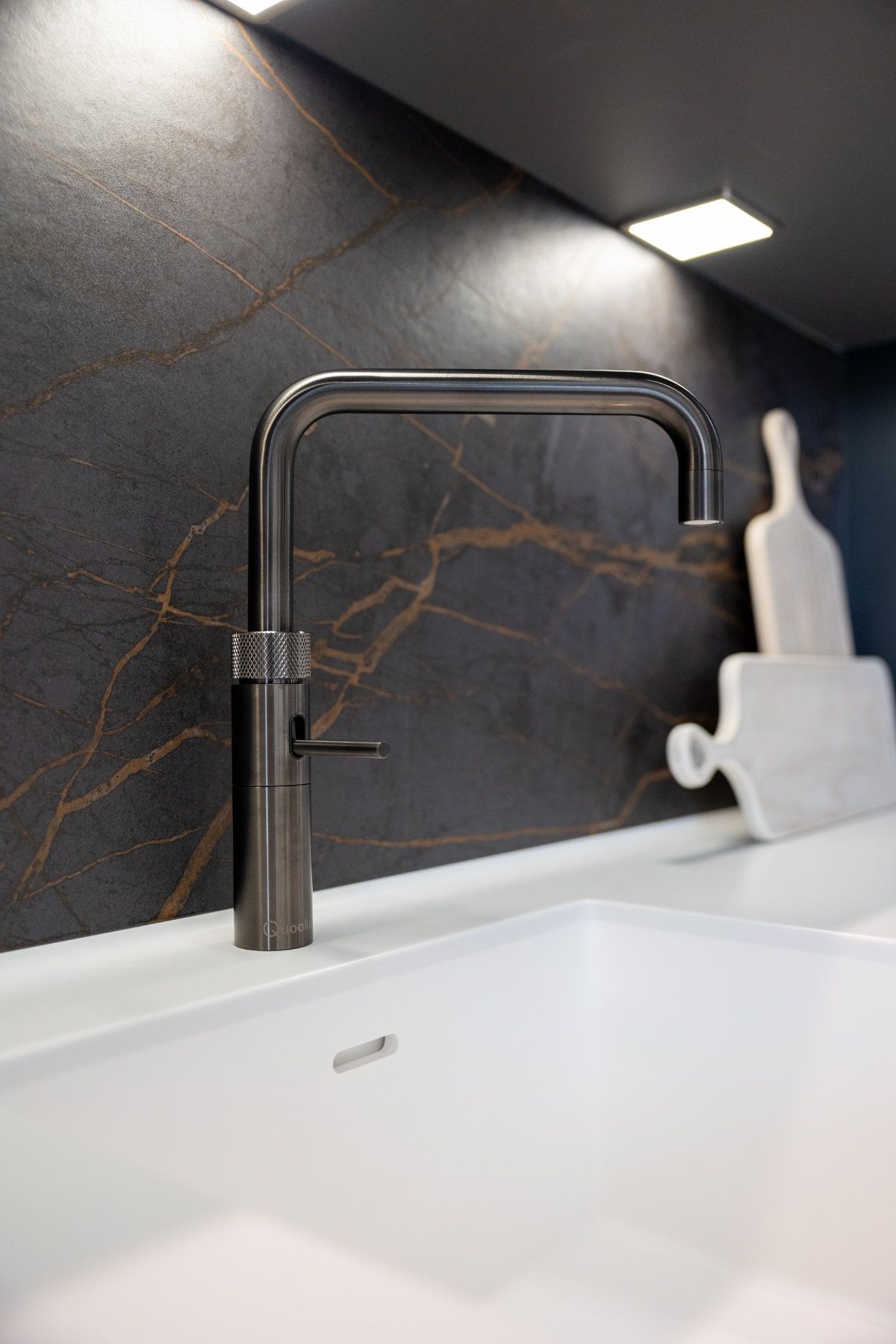A close up of a faucet on a sink in a kitchen.