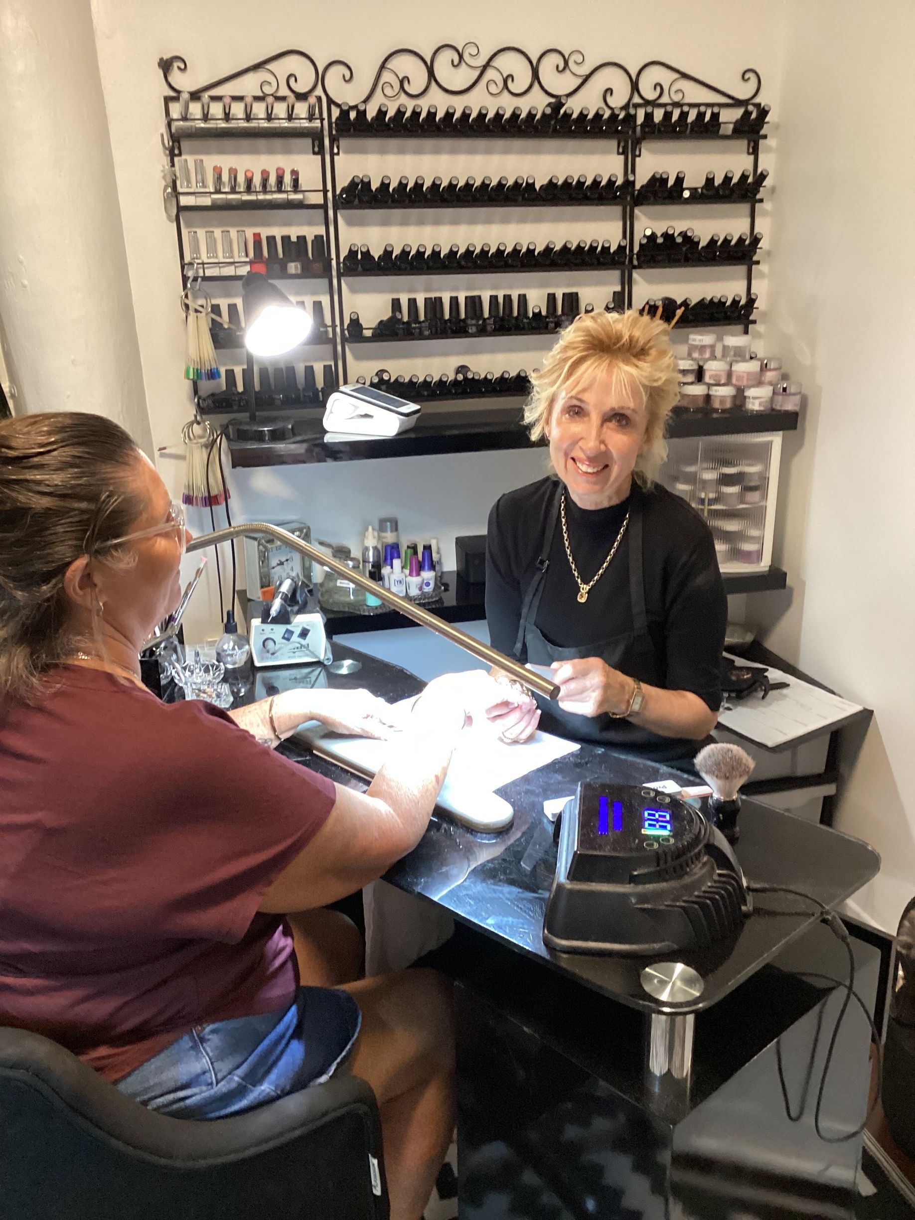 A Woman is Getting Her Nails Done in a Salon — Nailz By Dezign In Airlie Beach, QLD