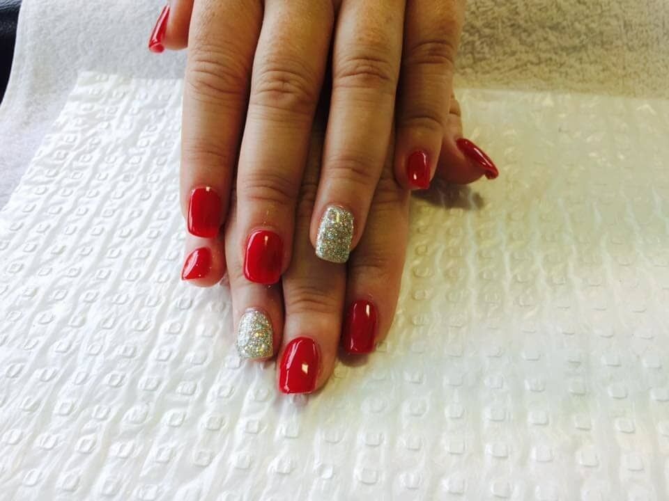 A Woman's Nails Are Painted Red and Silver and Are Sitting on a White Towel — Nailz By Dezign In Airlie Beach, QLD