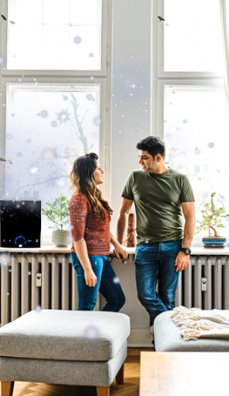 Two people chatting by a bright window in a modern living room