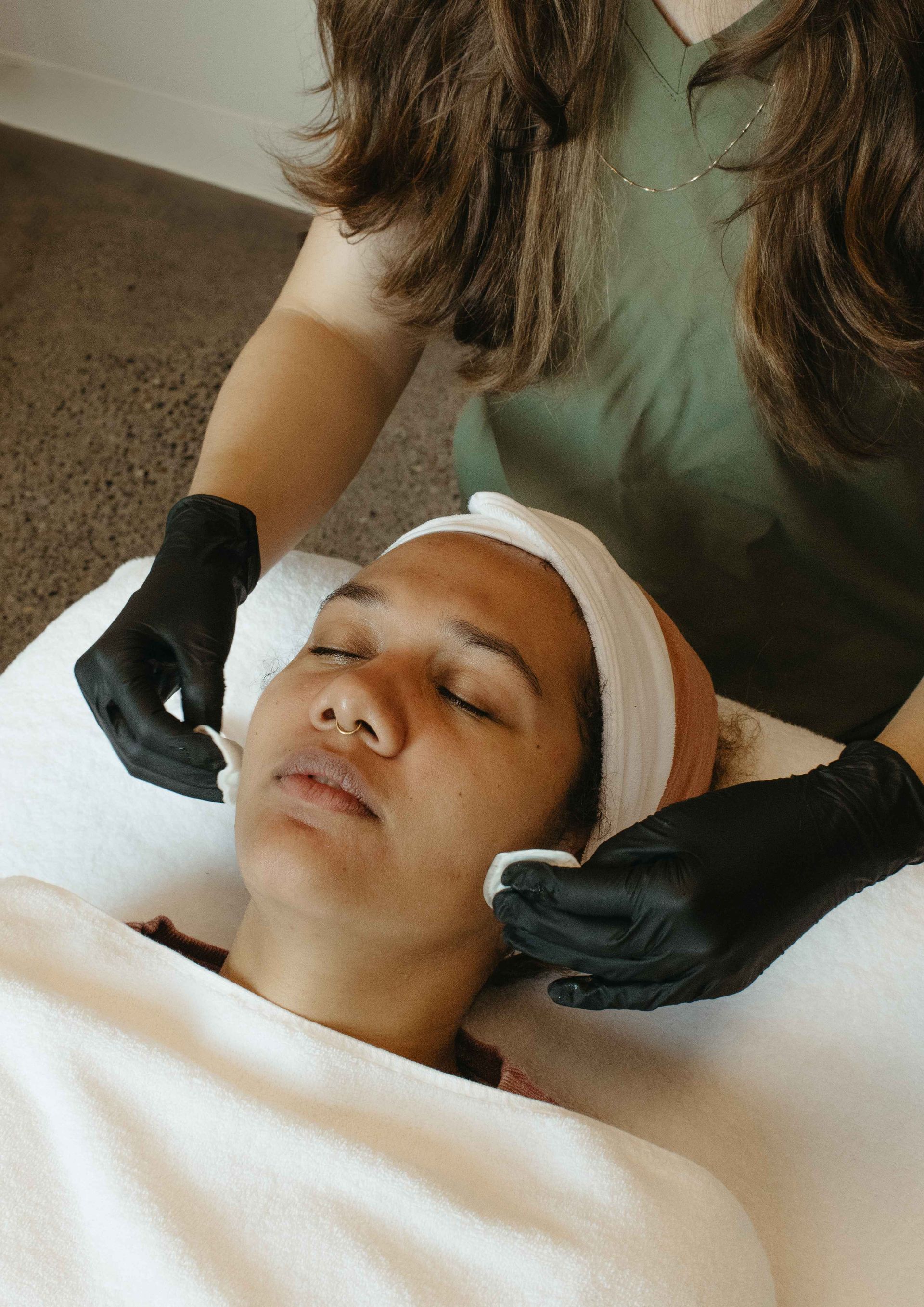 A woman is getting a facial treatment at a spa.