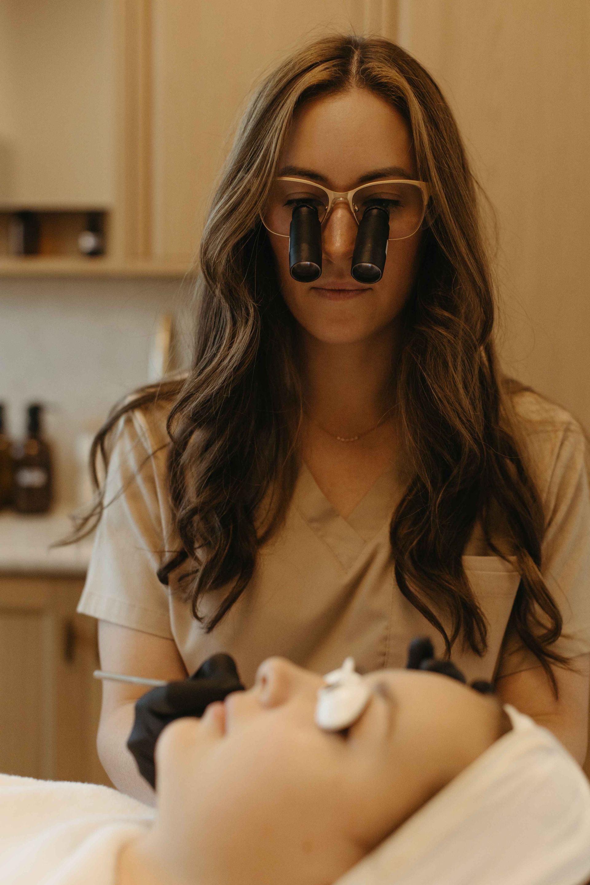 A nurse is sitting at a desk talking to a patient.
