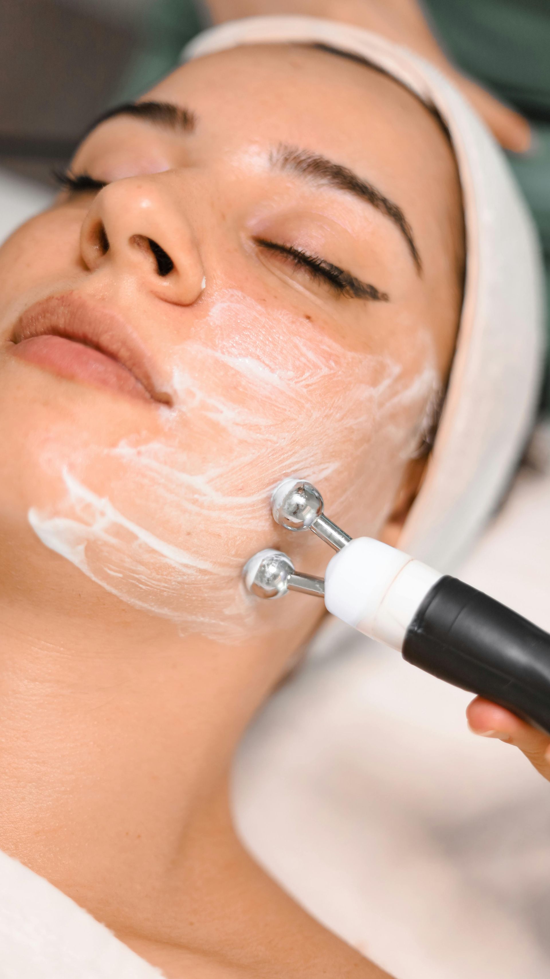 A woman is getting a facial treatment at a beauty salon.