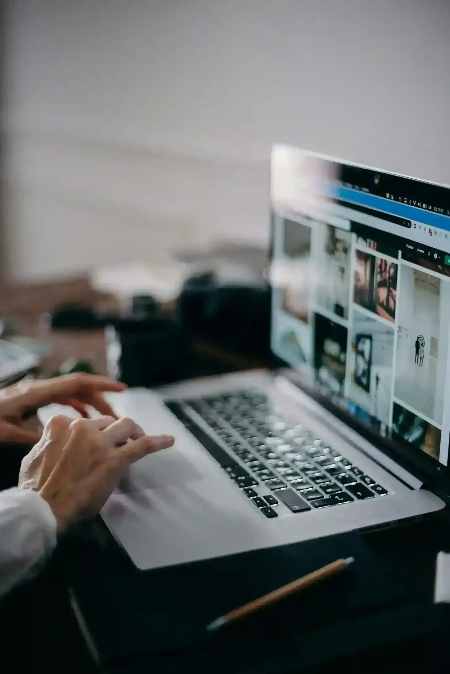 Hands typing on a laptop with images on the screen for Managed IT Services Connecticut