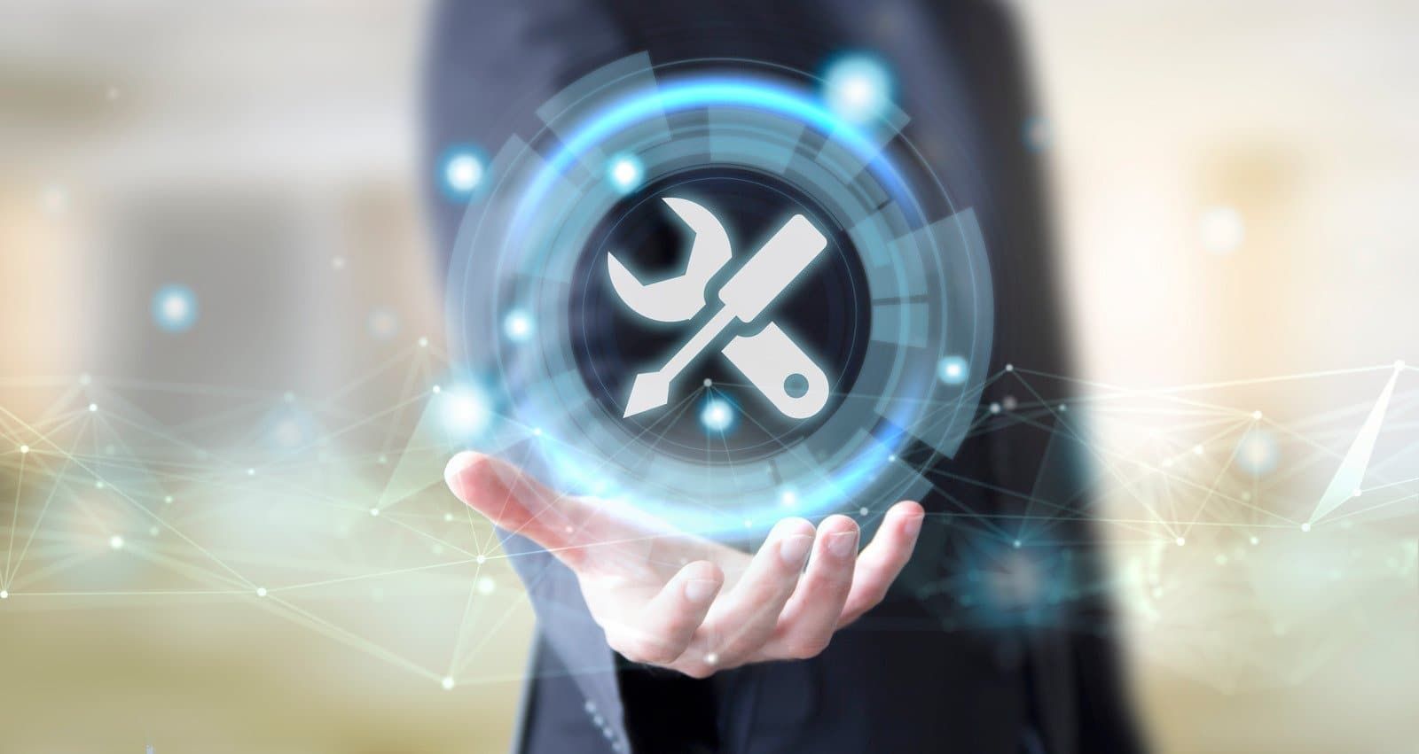 A man in a suit is holding a wrench and screwdriver icon in his hands.