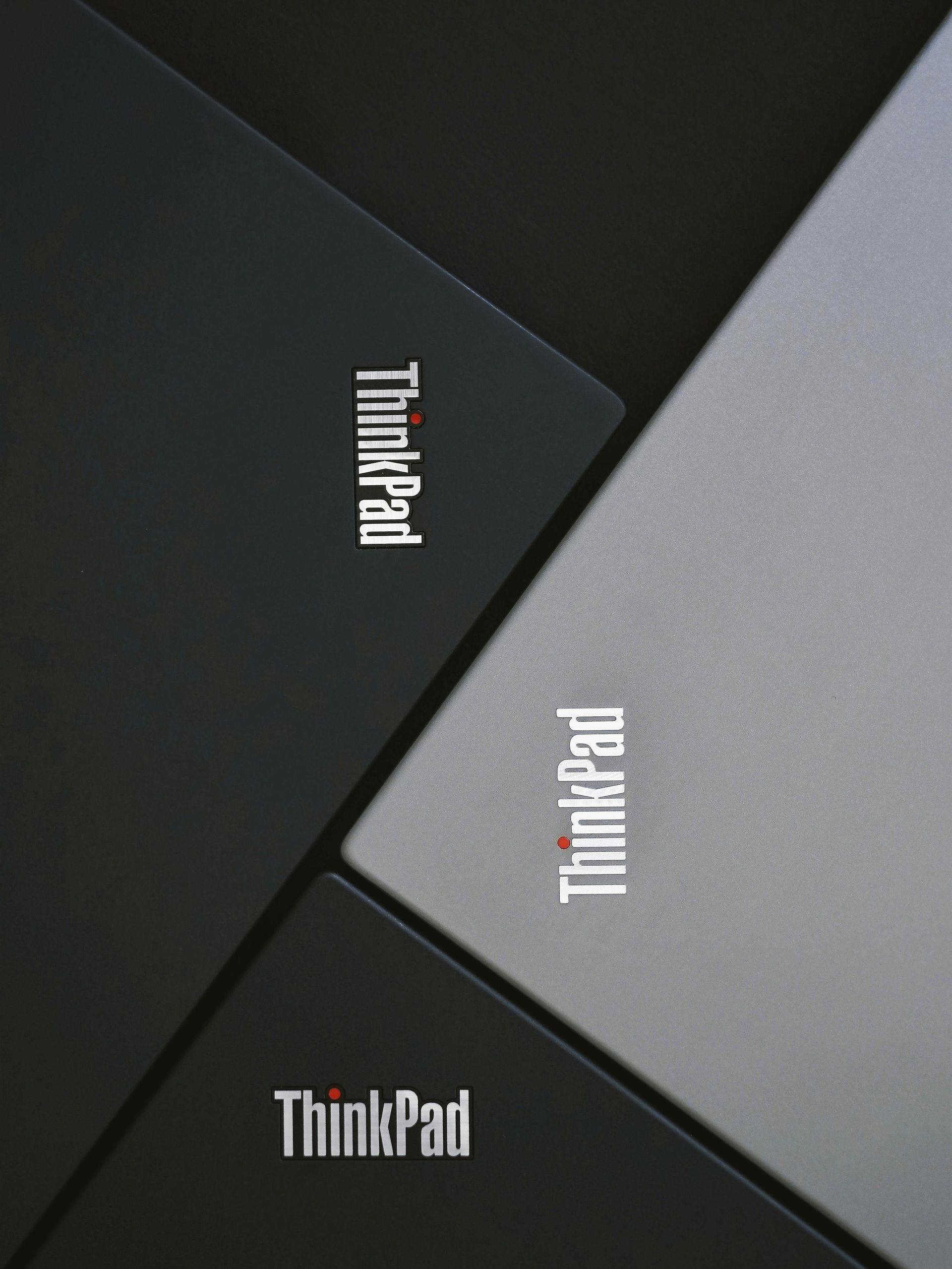 Three thinkpad laptops are stacked on top of each other