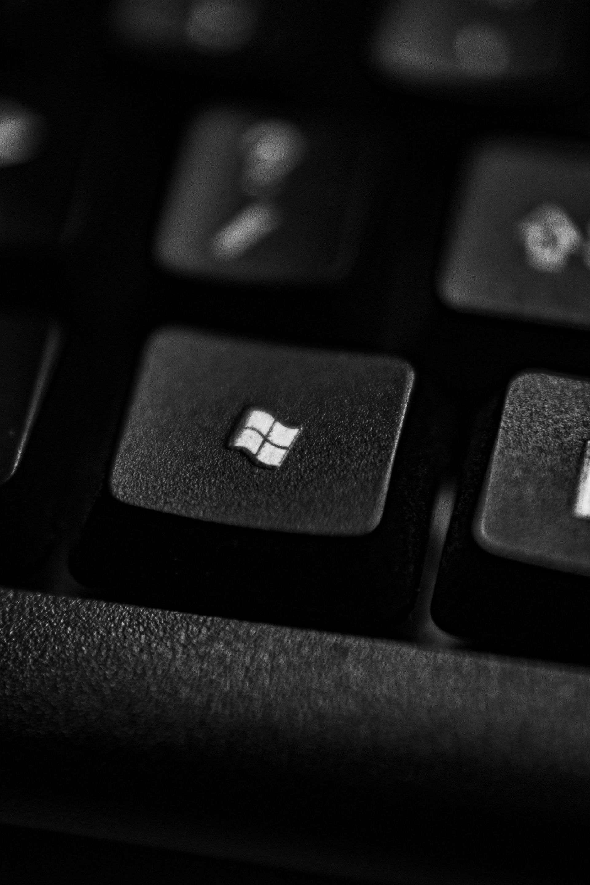 A close up of a black keyboard with a windows key on it.