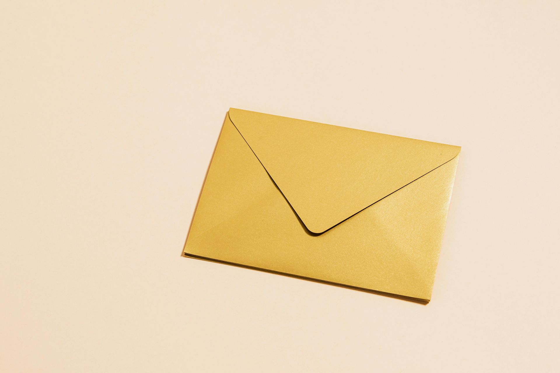 A yellow envelope is sitting on a white surface.