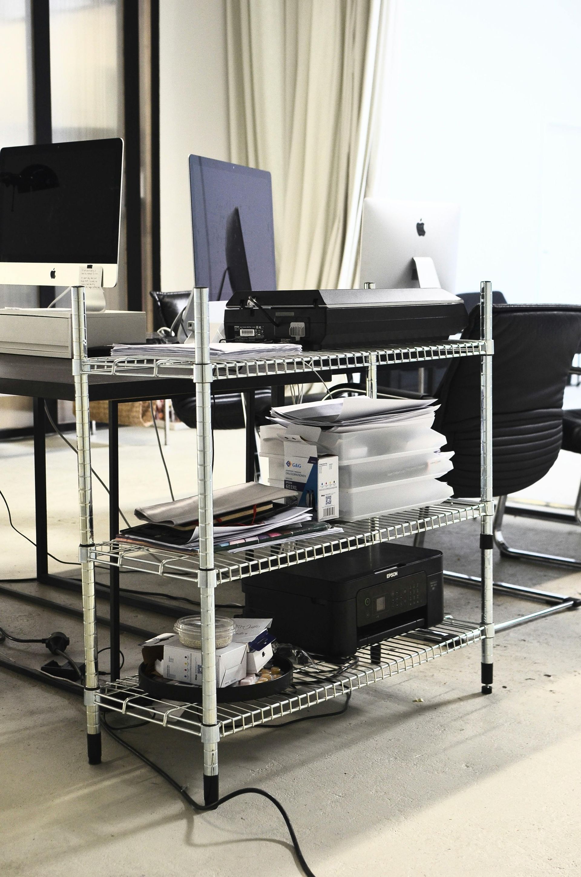 A desk with a computer monitor on top of it