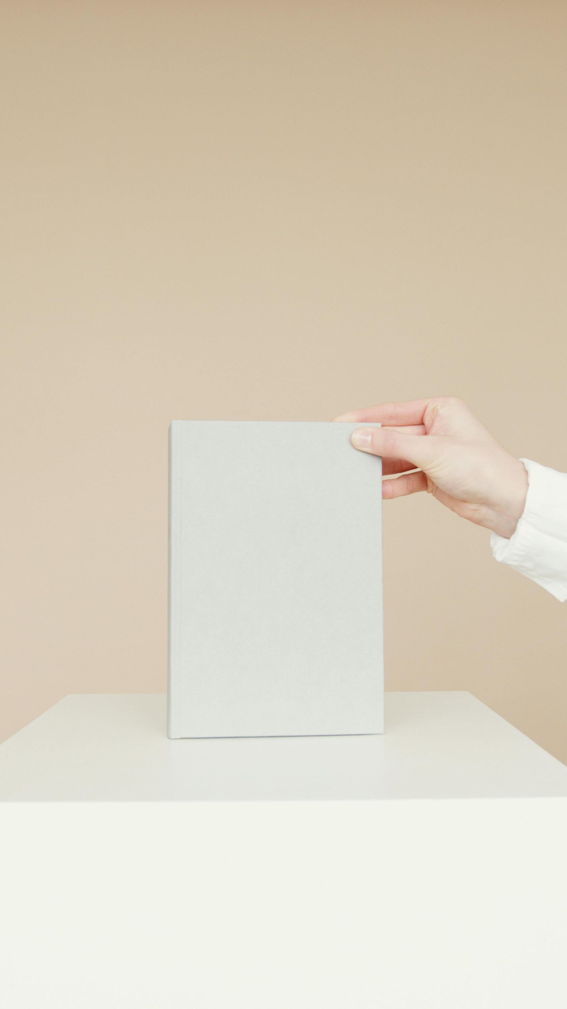 A person is holding a piece of paper in their hand.