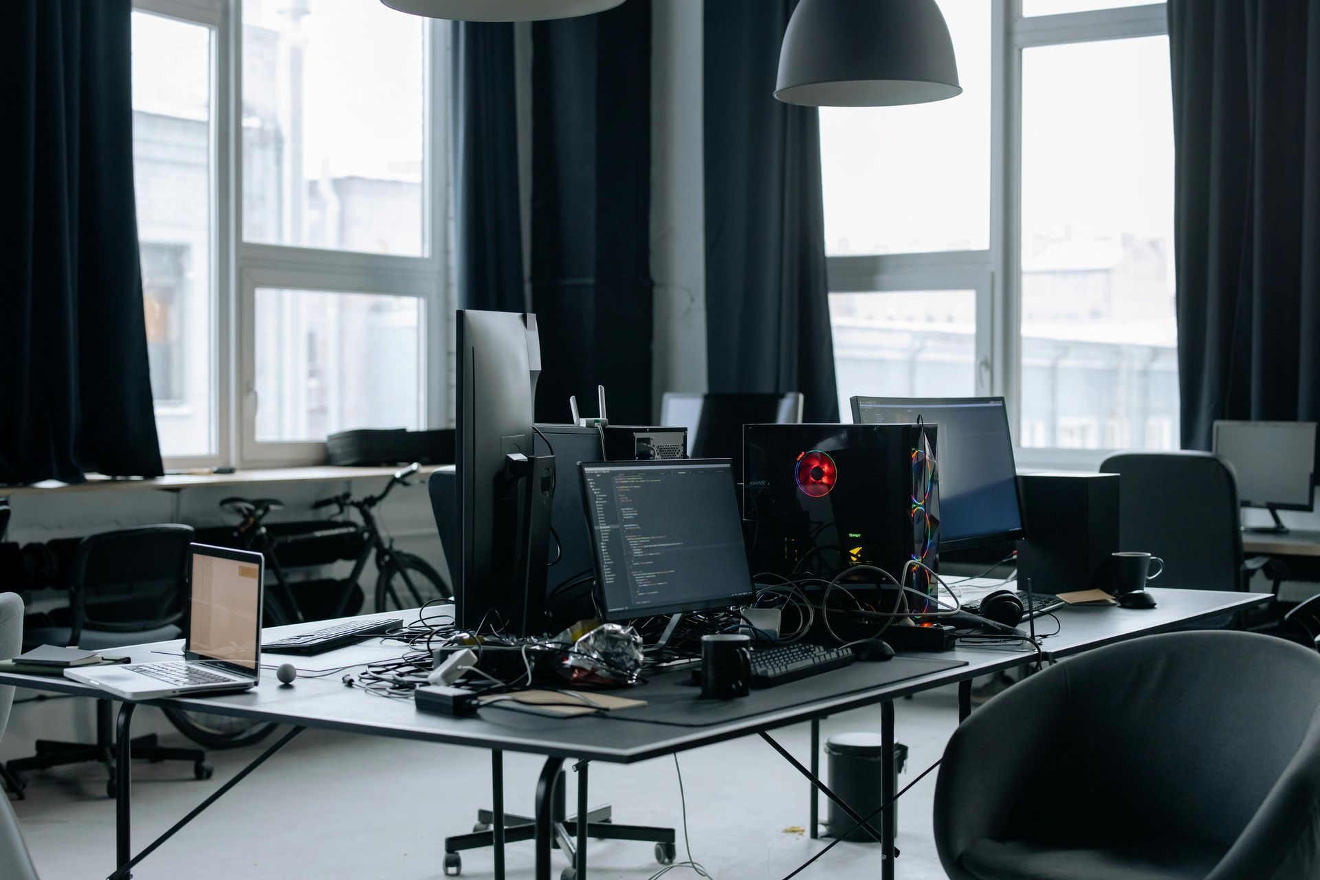 There are many computers on the desks in the office.