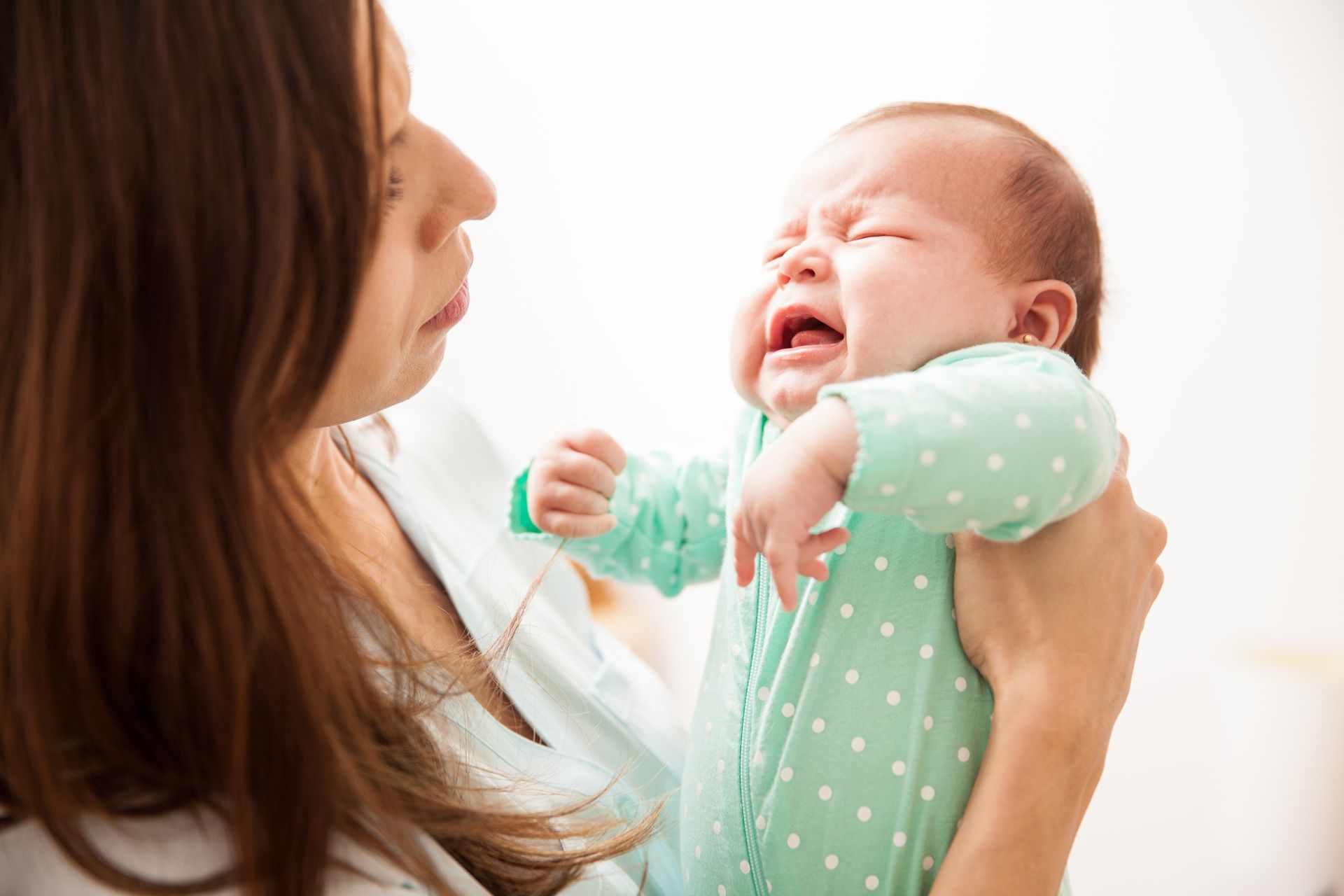 Child with croup and barky cough resting with a parent