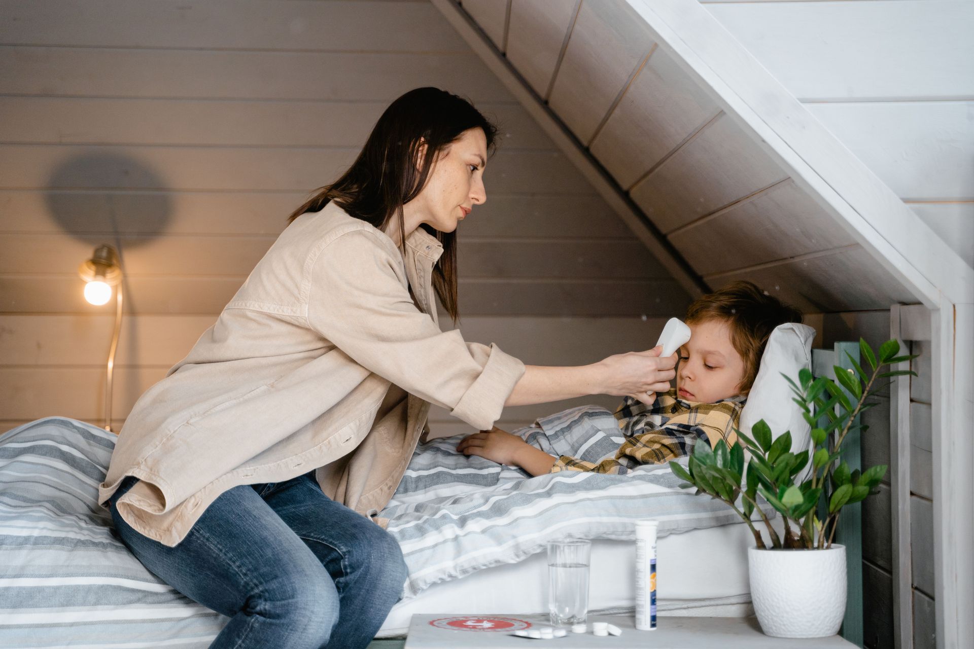 Fever in children: parent checking a child's temperature
