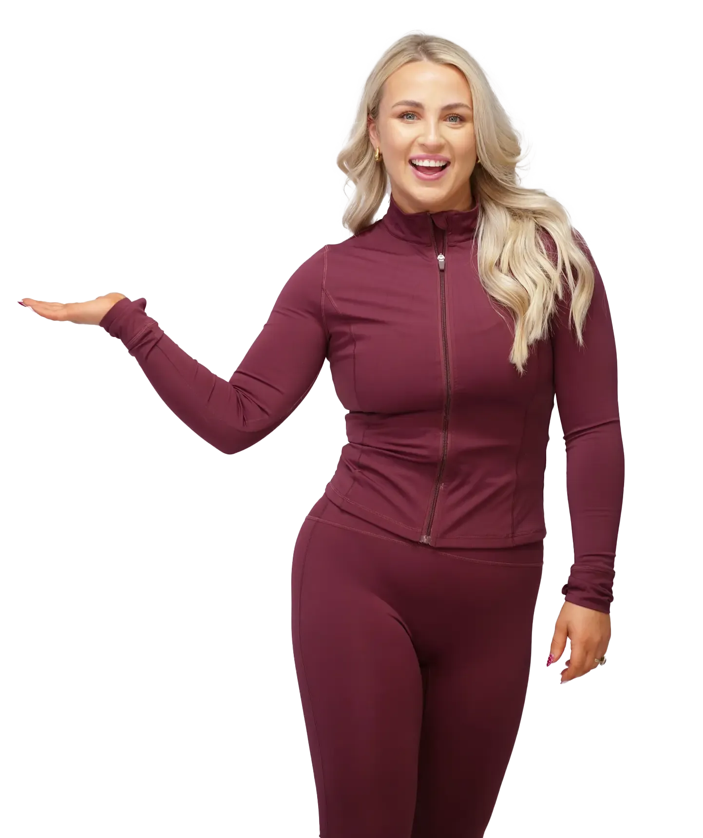 Woman in burgundy athletic wear gesturing with open hand, smiling.