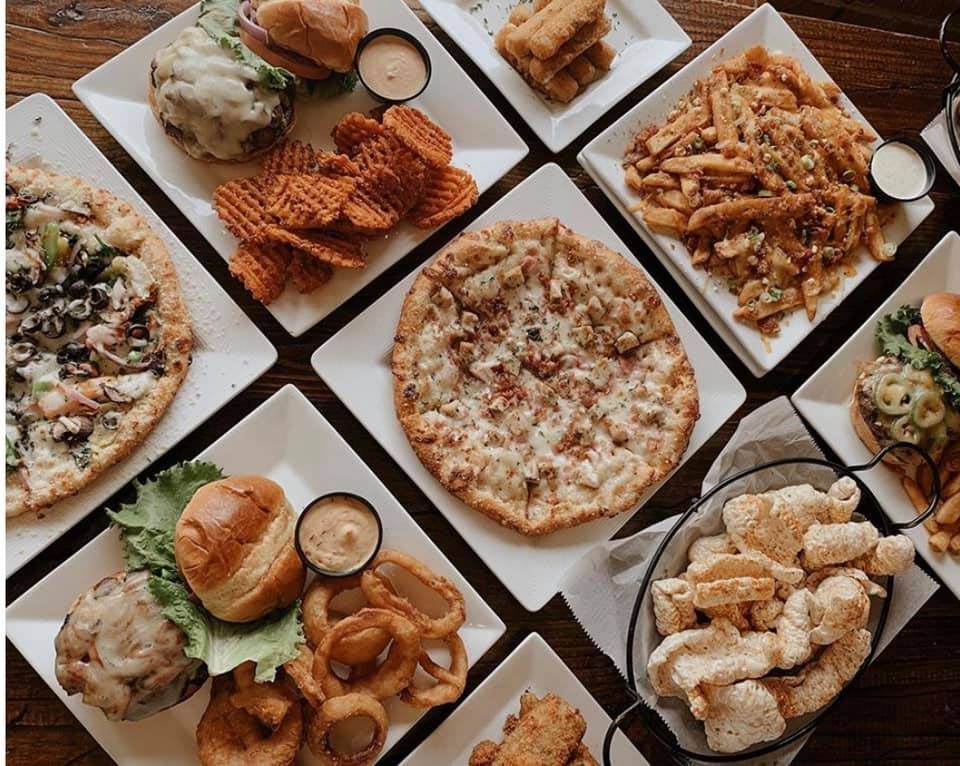 A close up of a plate of food with a drink in the background