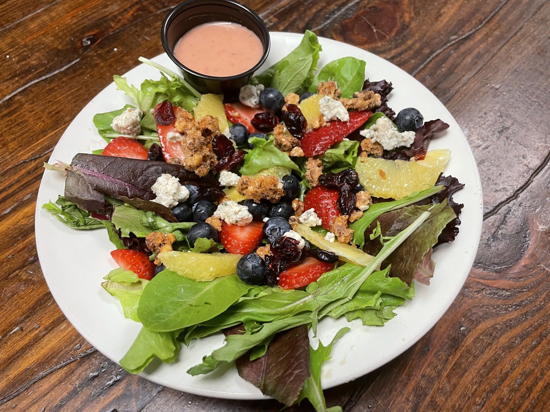 A close up of a salad in a bowl on a table.
