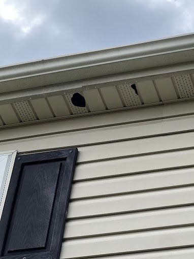 There is a hole in the roof of a house.