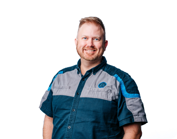 Man in blue-gray work shirt smiling against a white background