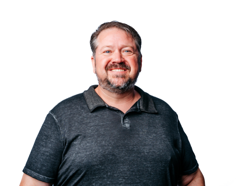 Smiling man in a dark gray polo shirt against a white background