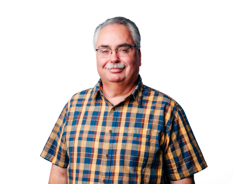 Smiling man in a blue and orange plaid shirt against a white background
