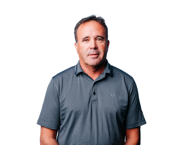 Man in a gray polo shirt standing against a white background
