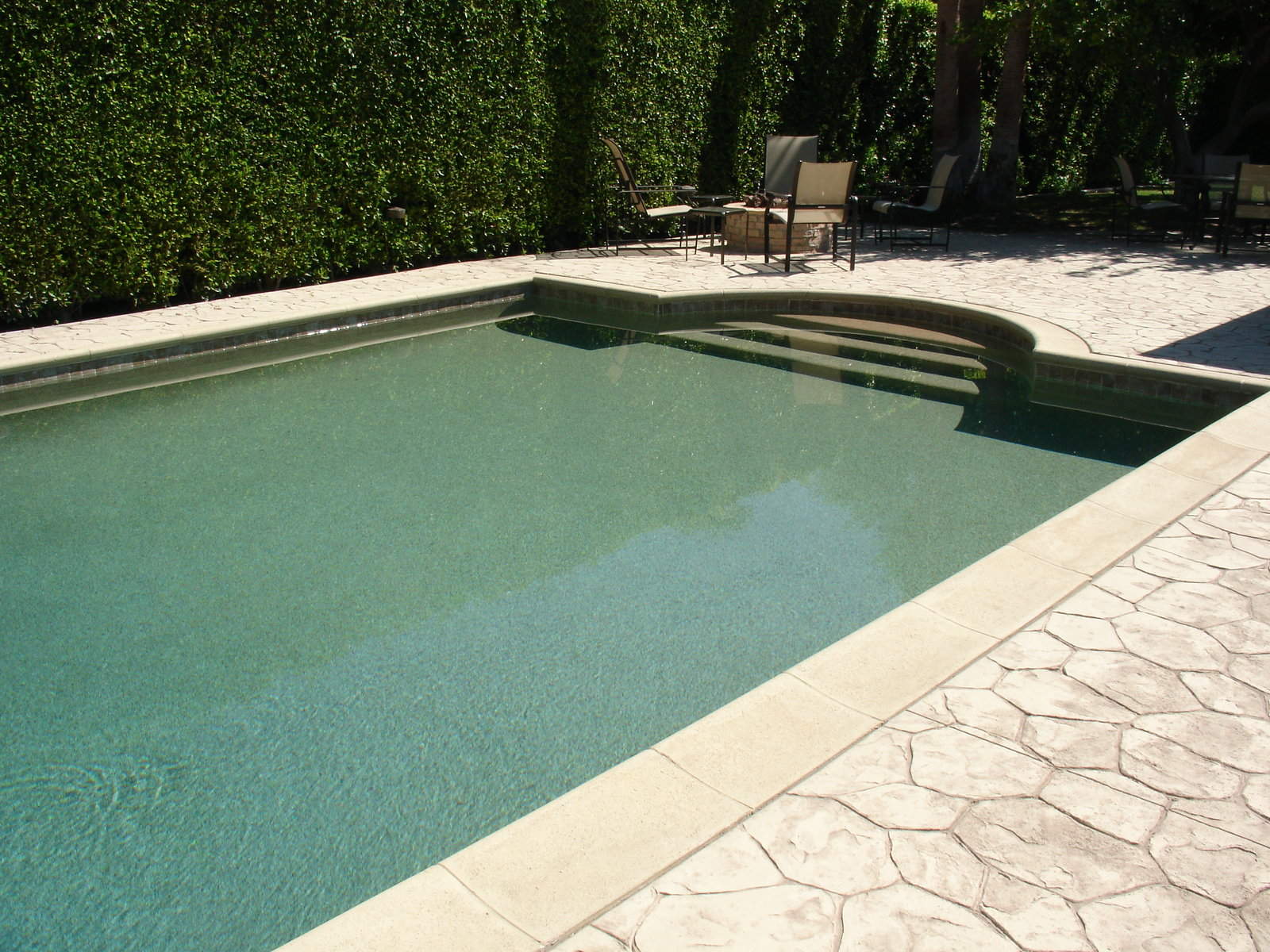 table and chairs near the pool