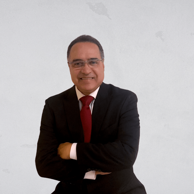 A man in a suit and tie with his arms crossed