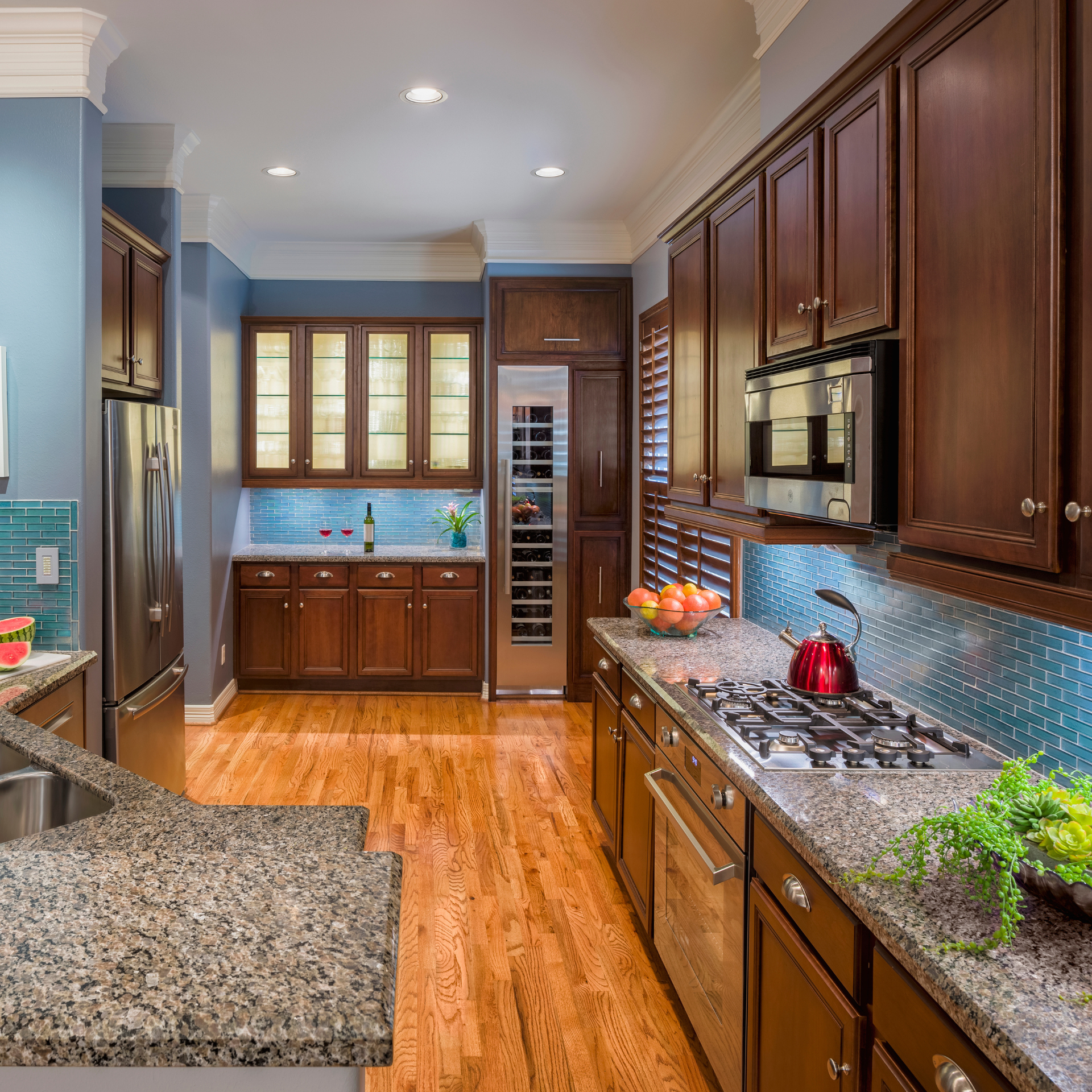 A kitchen with wooden cabinets and granite counter tops