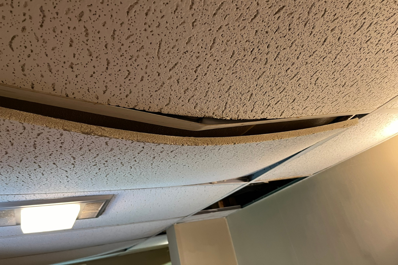 A ceiling with a hole in it and a light on it