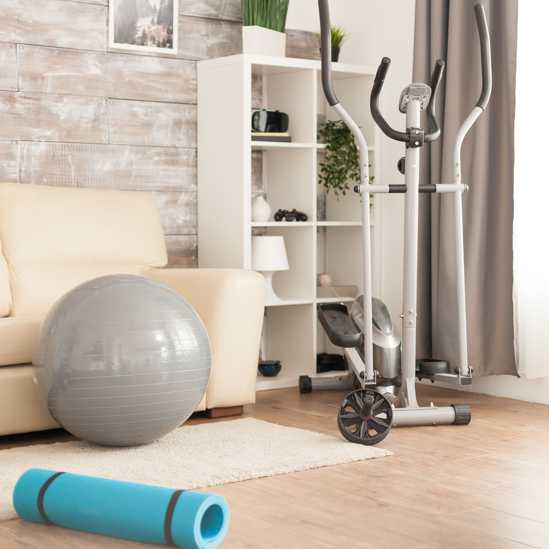 A living room with an exercise ball and a yoga mat