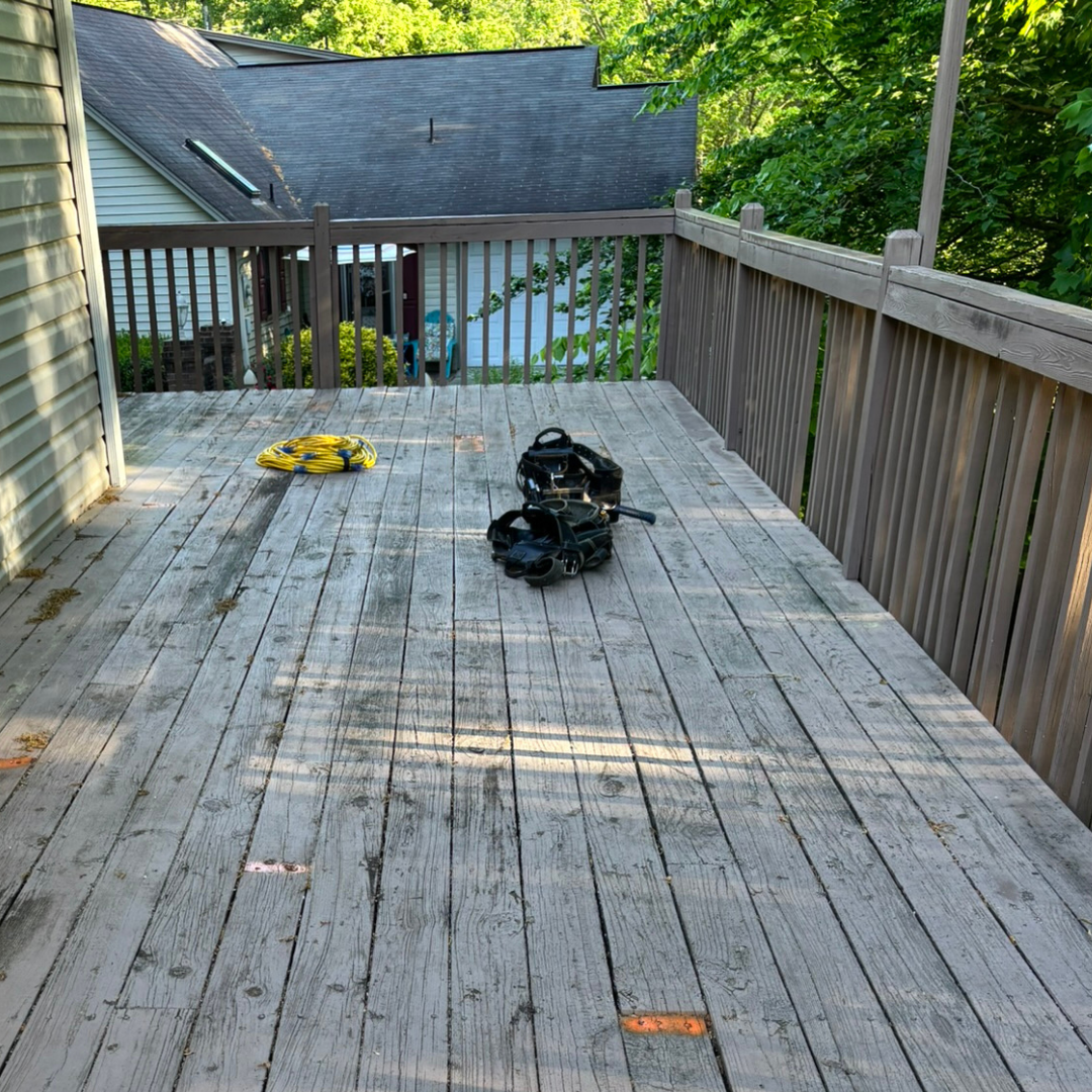 A close up of a wooden deck with a hole in it.