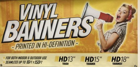 A poster for vinyl banners shows a woman holding a megaphone