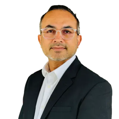 Professional headshot of a person in a dark suit and white shirt against a white background