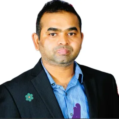 Studio portrait of a man in a dark blazer and blue shirt on a white background