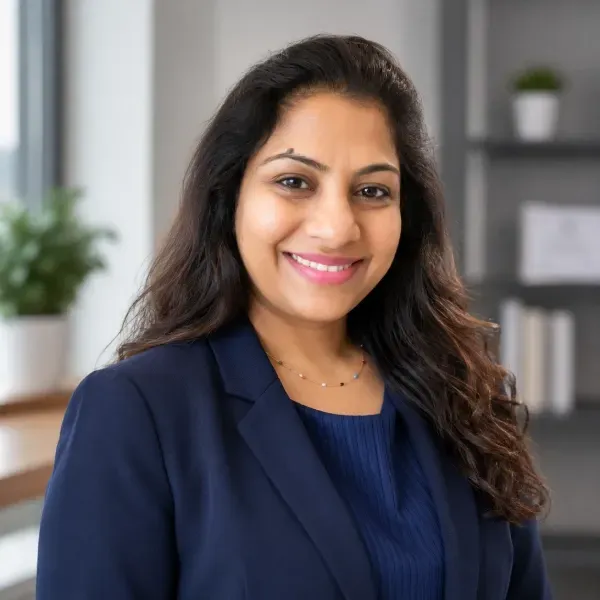 Smiling woman in a navy blouse in a bright office setting