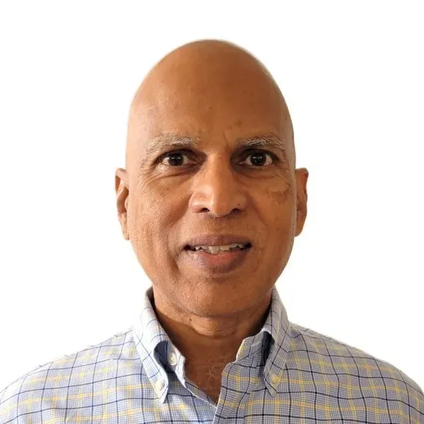 Head-and-shoulders portrait of a bald man smiling in a light plaid button-down shirt on a white background