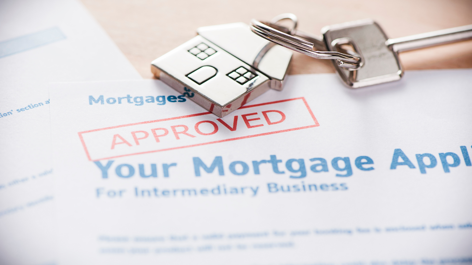 Mortgage application marked approved with house keys on the form