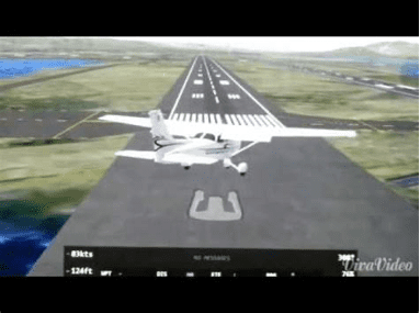 Small white airplane on runway approach, landing at a marked airport runway in daylight.