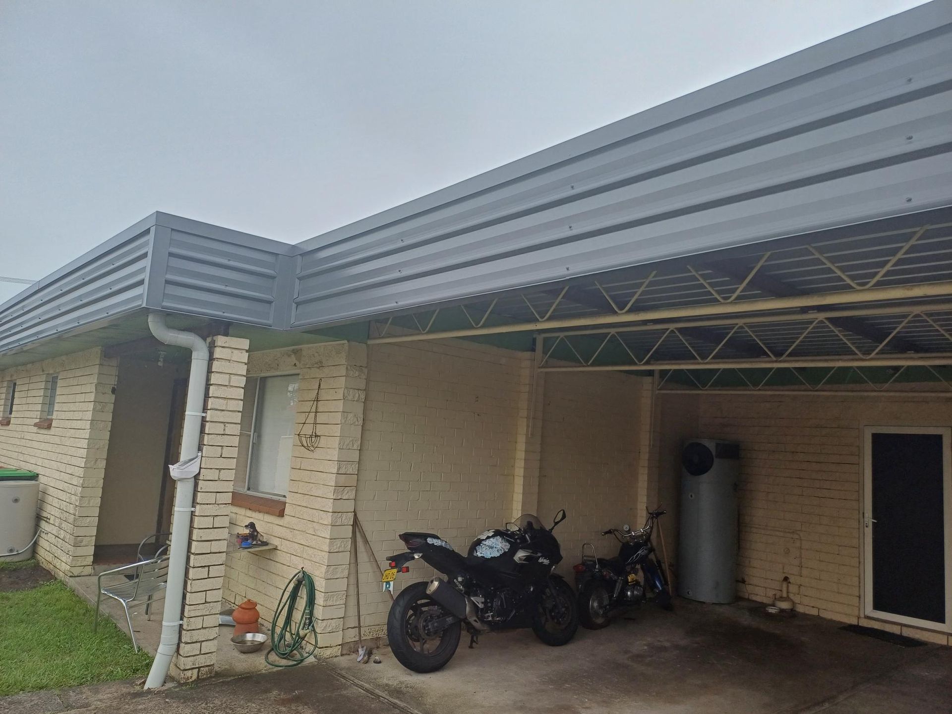 A picture of a house with gutters on the roof — Rooftech Roofing Services in Ballina, NSW