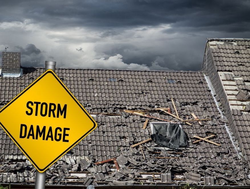 A Yellow Sign That Says Storm Damage — Rooftech Roofing Services in Ballina, NSW
