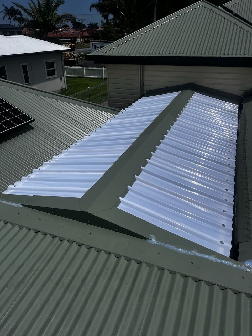 A Close up Of a Green And White Metal Roof— Rooftech Roofing Services in Lismore, NSW