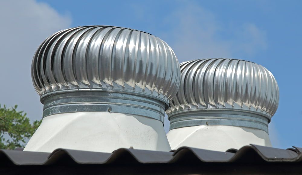 Two Metal Domes on Top of A Roof with A Blue Sky in The Background — Rooftech Roofing Services in Bangalow, NSW