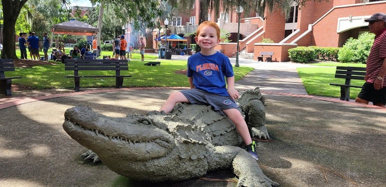 Boy on gator statue
