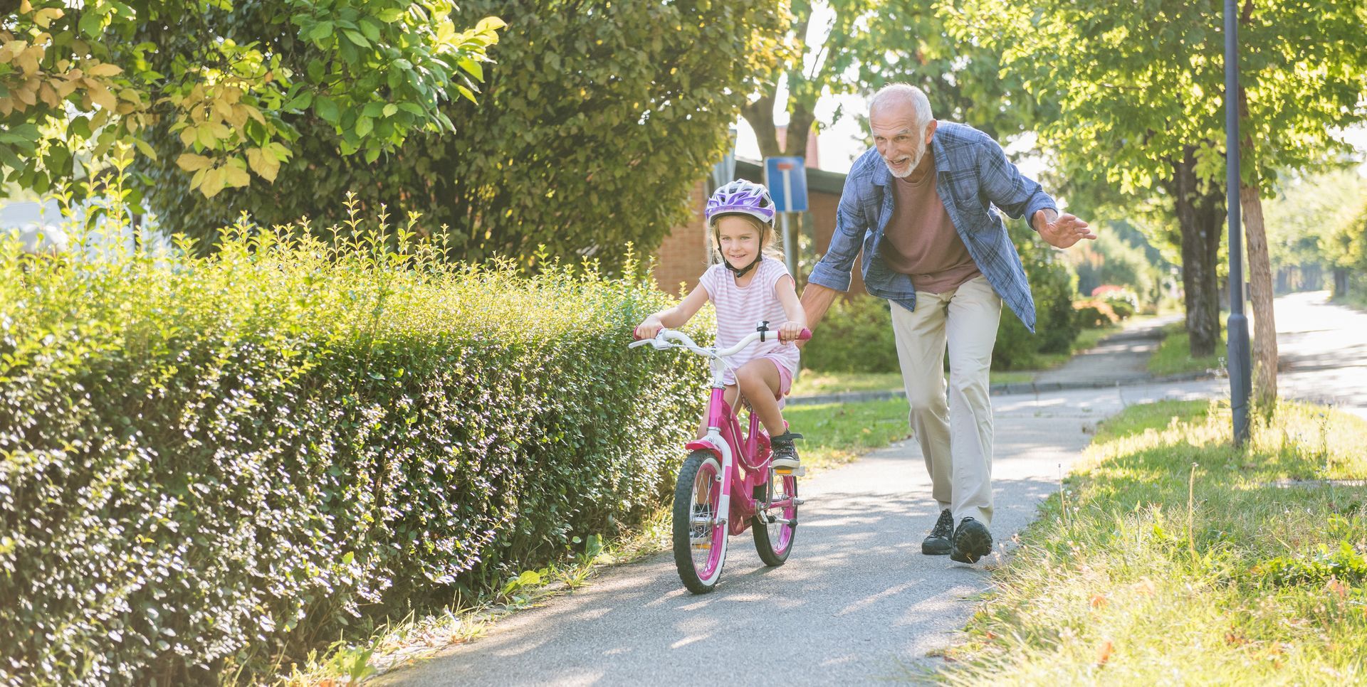 Grandpa teaches girl to bike
