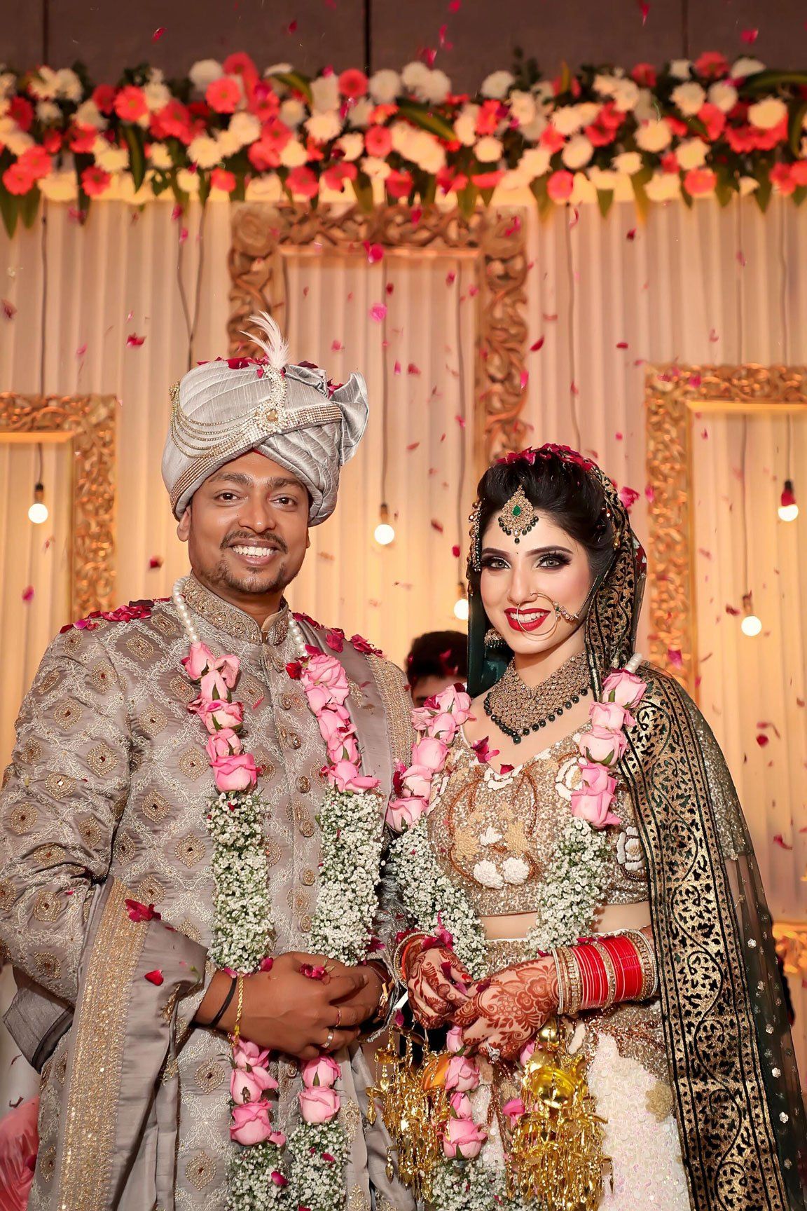 A couple smiling at camera 
