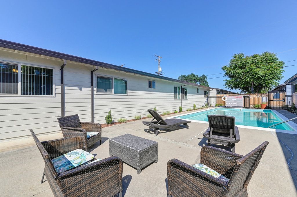 Back Side Swimming Pool with four chairs