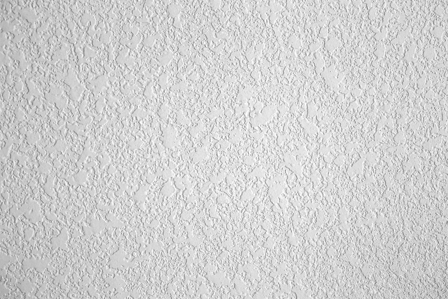 Close-up of a white textured wall surface