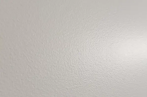 Blank white textured surface with a subtle diagonal shadow