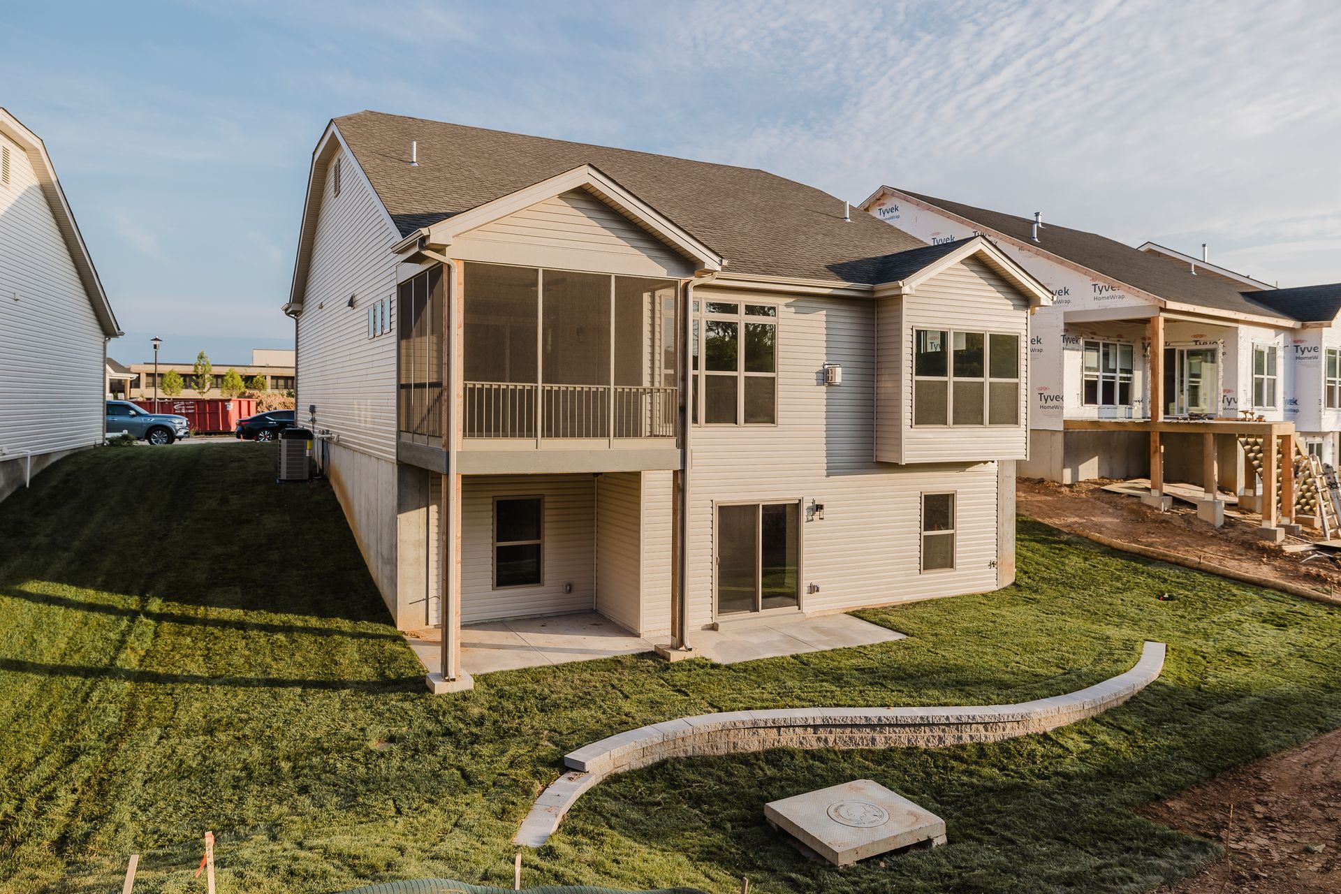 Back of the Humphrey Bogart model with a screened-in porch, built on a grassy hill.